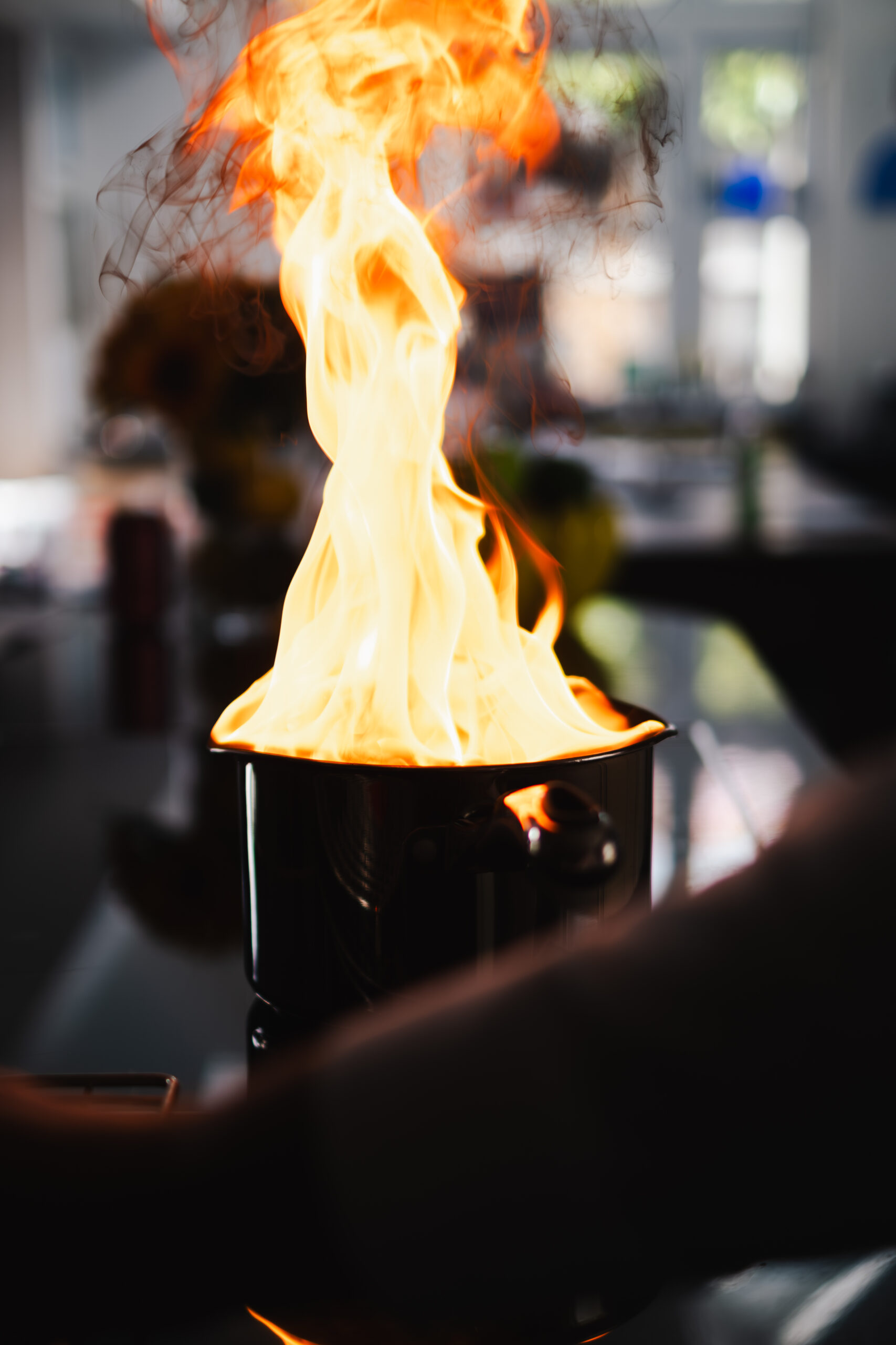 Flames rising from a metal container during fire suppression testing